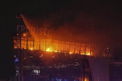 Krasnogorsk (Russian Federation), 22/03/2024.- Russian firefighters extinguish a fire on the Crocus City Hall concert venue following a shooting in Krasnogorsk, outside Moscow, Russia, 22 March 2024. A group of up to five gunmen has attacked the Crocus City Hall in the Moscow region, Russian emergency services told. At least 40 people were killed and more that 100 injured in the terrorist attack, the Russian intelligence service FSB said. (Terrorista, Atentado terrorista, Rusia, Moscú) EFE/EPA/VASILY PRUDNIKOV