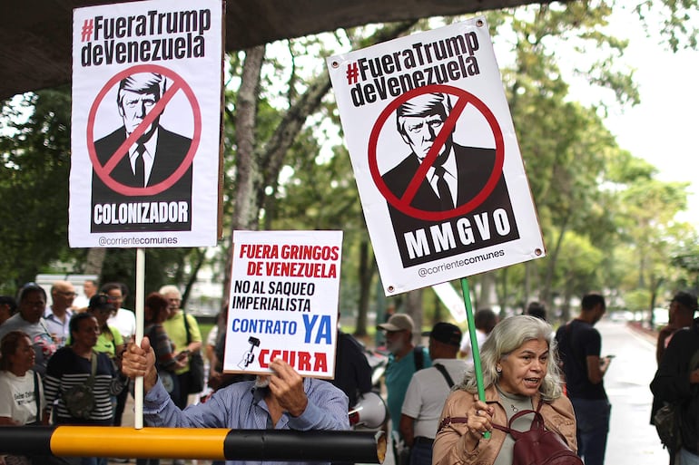 Personas sostienen carteles con la imagen del presidente de Estados Unidos, Donald Trump