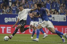 El delantero francés del Real Madrid Kylian Mbappé (i) lanza a portería durante el partido de LaLiga que enfrenta al Real Oviedo y al Real Madrid este domingo en el estadio Carlos Tartiere. EFE/Paco Paredes