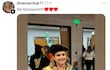 Dina Marchuk sonríe mientras sostiene su certificado de doctorado de la Universidad Columbia vestida con toga negra y birrete, en un ambiente festivo.