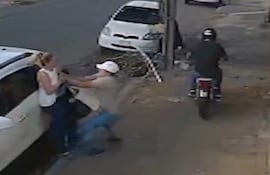 Momento en el que uno de los asaltantes intenta despojar a la mujer de su celular. El conductor de la moto fallecería después.