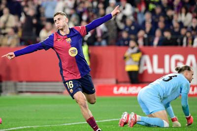 Barcelona's Spanish midfielder #16 Fermin Lopez (L) celebrates scoring his team's second goal during the Spanish league football match between Sevilla FC and FC Barcelona at Ramon Sanchez Pizjuan Stadium in Seville on February 9, 2025. (Photo by CRISTINA QUICLER / AFP)