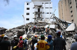 Equipos de rescate y voluntarios buscan supervivientes entre los escombros de un edificio derrumbado tras el terremoto que sacudió Cali, Colombia.