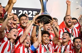 En un gran gesto del capitán de Estudiantes de La Plata, Santiago Lionel Ascacíbar, el lateral paraguayo, Santiago Arzamendia eleva el Trofeo de Campeones de la Superliga Argentina.