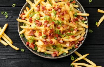 Papas fritas con cheddar y panceta.