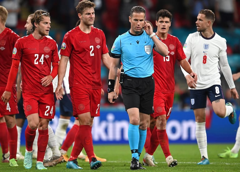 El colegiado neerlandés Danny Makkelie consulta con los asistentes del VAR el penalti a favor de la selección inglesa durante el encuentro correspondiente a la segunda semifinal de la Eurocopa.