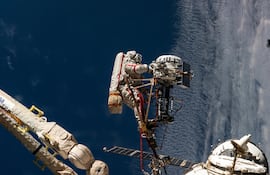El cosmonauta de Roscosmos Sergey Ryzhikov aparece al final del brazo robótico europeo mientras trabaja en una cámara de alta resolución durante una caminata espacial de seis horas y nueve minutos fuera de la Estación Espacial Internacional el 16 de octubre de 2025.