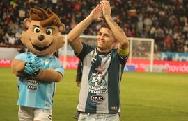 Fernando Ovelar, 19 años, futbolista paraguayo del Pachuca. Al lado, la mascota del club.