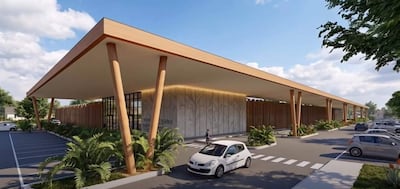 Edificio moderno con techado de columnas de madera, vegetación entorno y dos coches estacionados.