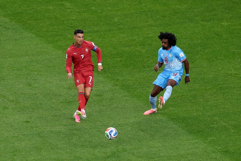 El capitán portugués Cristiano Ronaldo asiste a un compañero ante Samuel Moutoussamy.
