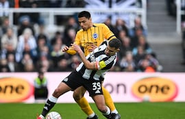 Brighton's Paraguayan midfielder #25 Diego Gomez (L) fights for the ball with Newcastle United's Brazilian midfielder #39 Bruno Guimaraes during the English FA Cup fifth round football match between Newcastle United and Brighton and Hove Albion at St. James' Park in Newcastle-upon-Tyne, north east England on March 2, 2025. (Photo by ANDY BUCHANAN / AFP) / RESTRICTED TO EDITORIAL USE. No use with unauthorized audio, video, data, fixture lists, club/league logos or 'live' services. Online in-match use limited to 120 images. An additional 40 images may be used in extra time. No video emulation. Social media in-match use limited to 120 images. An additional 40 images may be used in extra time. No use in betting publications, games or single club/league/player publications. /