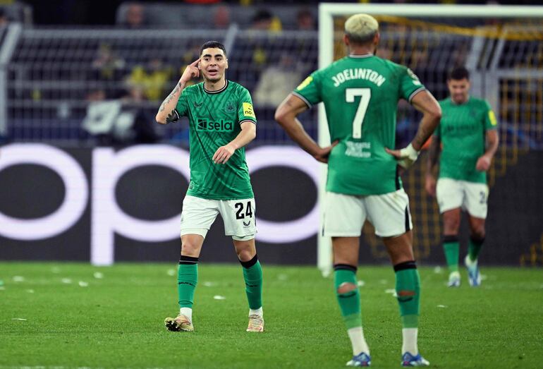 El centrocampista paraguayo #24 del Newcastle United Miguel Almirón (L) reacciona durante el partido de fútbol del Grupo F de la Liga de Campeones de la UEFA entre el BVB Borussia Dortmund y el Newcastle United FC en Dortmund, Alemania occidental, el 7 de noviembre de 2023.