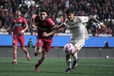 Rafael Inzunza y el paraguayo Robert Morales disputan el balón durante el partido del miércoles entre Tijuana y Toluca, por la Liga mexicana.