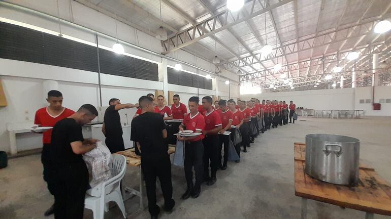 Los aspirantes a policía, forman filas a la hora del almuerzo en el local del Centro Agropecuario de Pilar,