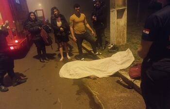 La víctima tendida en el pavimento, cerca de la columna contra la que impactó.