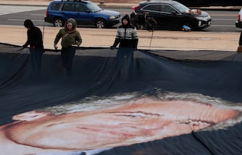 Un cartel gigante que muestra a Jeffrey Epstein y al presidente estadounidense Donald Trump es desplegado cerca del Capitolio de Washington, ayer lunes.