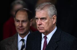 Duke of York reacts as he leaves at the end of the Royal Family's traditional Christmas Day service at St Mary Magdalene Church in Sandringham, Norfolk, eastern England, on December 25, 2022. UK police said February 19, 2026, officers were searching two addresses, one in eastern England and one west of London, following the arrest of ex-Prince Andrew on suspicion of misconduct in a public office. New revelations last week appeared to show Andrew sent convicted sex offender Jeffrey Epstein potentially confidential documents during his time as a UK trade envoy. (Photo by Daniel LEAL / AFP)