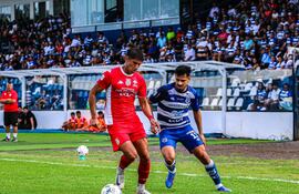 El defensor de General Cabalero de Juan León Mallorquín, Alexis Rodas controla el esférico ante la presión del delantero de Sportivo 2 de Mayo, Rodrigo Ruiz Díaz.