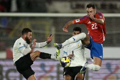 Uruguay's defender #08 Nahitan Nandez and Chile's forward #22 Ben Brereton fight for the ball during the 2026 FIFA World Cup South American qualifiers football match between Chile and Uruguay at the Julio Martinez Pradanos Nacional stadium in Santiago on September 9, 2025. (Photo by Rodrigo ARANGUA / AFP)