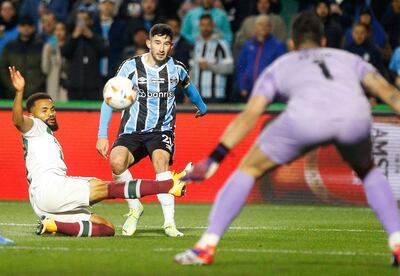 Fluminense's defender Samuel Xavier (L) and Gremio's Praguayan forward Mathías Villasanti fight for the ball during the Copa Libertadores round of 16 first leg all-Brazilian football match between Gremio and Fluminense, at the Arena do Gremio stadium, in Porto Alegre, Brazil, on August 13, 2024. (Photo by Albari Rosa / AFP)