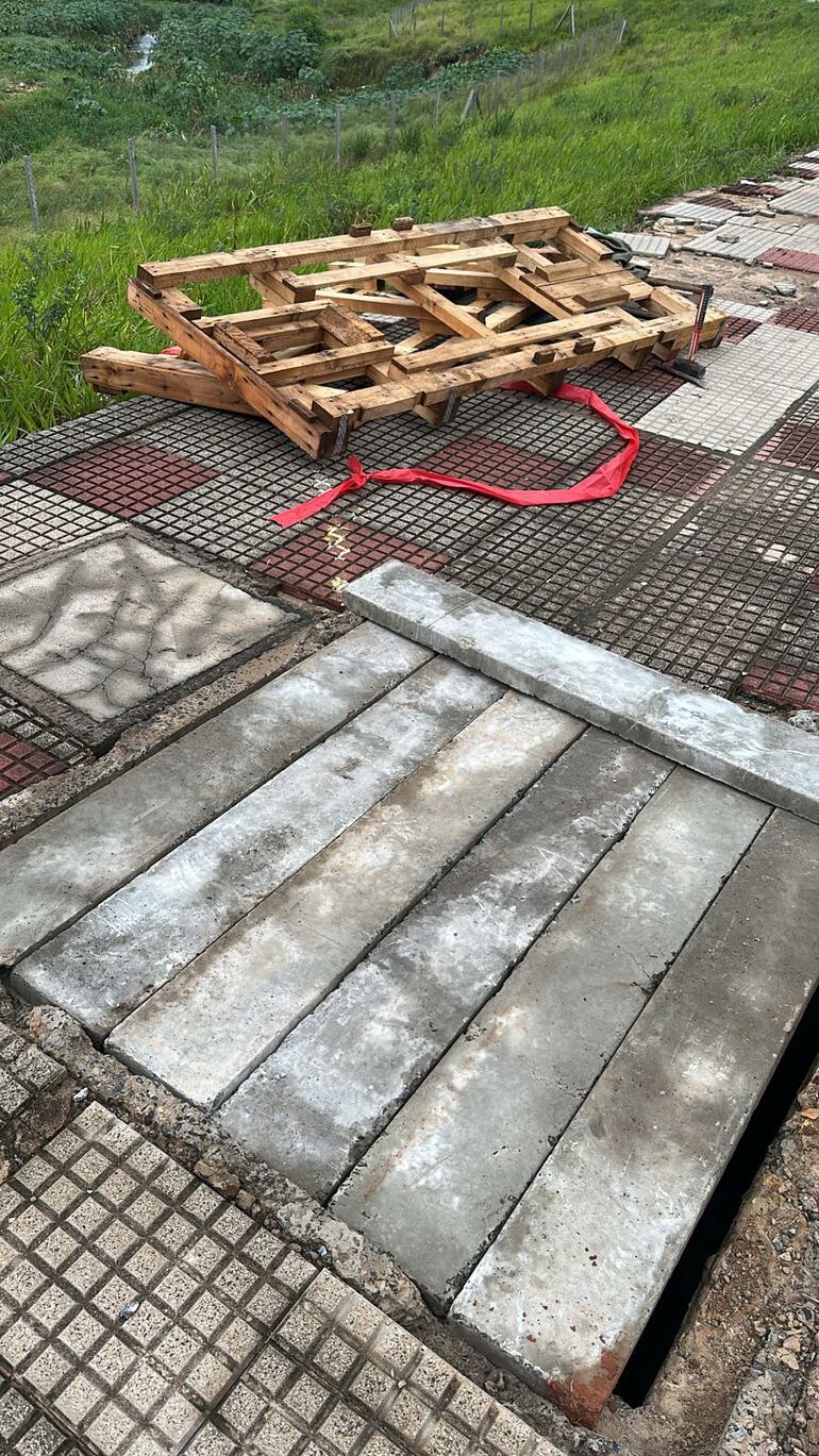 Agujero de la Costanera recién tapado. De fondo se ven los materiales con los que se había colocado un precario vallado.