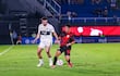 El lateral neozelandés de Olimpia, Tim Payne intenta avanzar por la banda ante la marca del extremo de Sportivo Ameliano, Luis Ortiz.