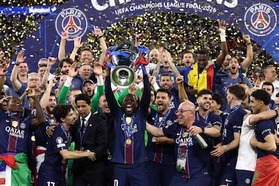 Paris Saint-Germain's French forward #10 Ousmane Dembelelifts the trophy as he celebrates with teammates after winning the UEFA Champions League final football match between Paris Saint-Germain (PSG) and Arsenal FC at the Puskas Arena in Budapest on May 30, 2026. (Photo by FRANCK FIFE / AFP)