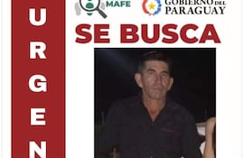 Cartel de búsqueda con foto de Julio César Velázquez Cabrera, vestimenta azul y detalles de su desaparición.