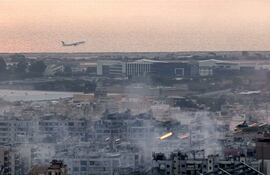 An aircraft of Middle East Airlines (MEA), Lebanon's flag carrier, takes off from Beirut International Airport on October 6, 2024 amidst smoke rising from nearby sites targeted overnight by Israeli air strikes in the southern suburbs of the Lebanese capital. (Photo by AFP)