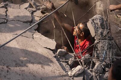 Un rescatista trabaja entre los escombros de un edificio destruido en medio de bombardeos en Jan Yunis, en la Franja de Gaza, este lunes.