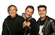 Los Nocheros sonríen luciendo abrigos y chaquetas, en un retrato frontal armonioso sobre fondo blanco.