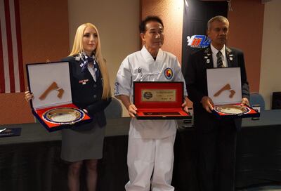 Angelike Augsten, Hwang Chi Gon y César Ozuna en el acto de reconocimiento en Miami, EE.UU.