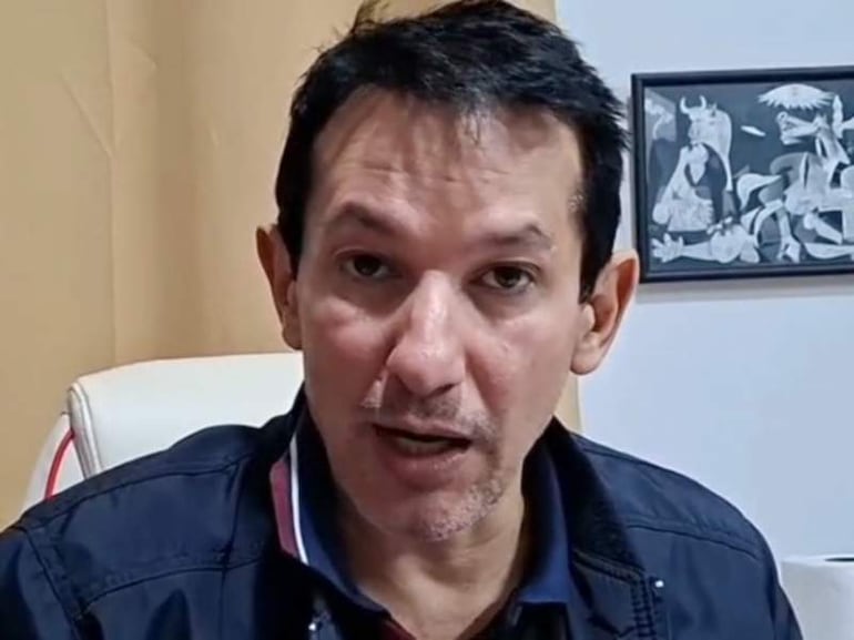 Juan Daniel Benítez Miranda en chaqueta oscura, sentado con expresión seria en una sala de entrevistas con fondo beige.