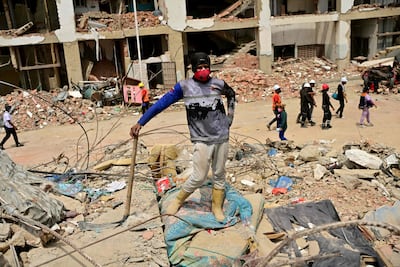 A Venezuelan rescuerstands atop rubble while trying to retrieve bodies, in the Caribe sector of Caraballeda, La Guaira state, Venezuela, on July 6, 2026, following earthquakes that struck the region. The earthquakes that struck Venezuela on June 24 have claimed the lives of at least 3,342 people, the Venezuelan government reported on July 5. (Photo by MARTIN BERNETTI / AFP)