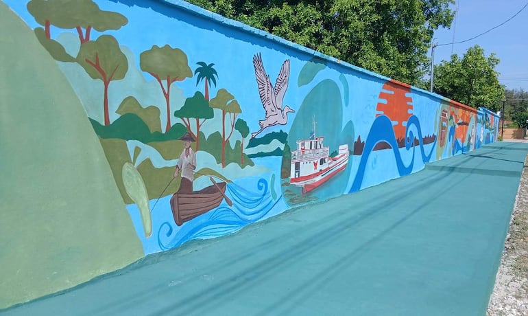 El mural fue plasmado en la muralla de la Parroquia de la Santa Cruz, convirtiendo un espacio tradicional de la comunidad en una propuesta artística que representa parte de su historia y su presente