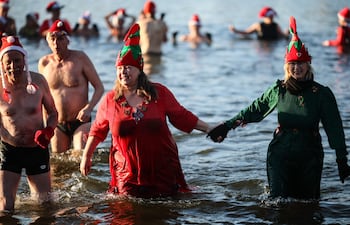 Docenas de personas con gorros de Papá Noel se bañaron en este día de Navidad en el lago berlinés de Orankesee