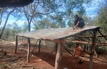 Un poblador de la comunidad trabaja en la construcción de una precaria vivienda en el interior del asentamiento.