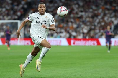 Real Madrid's French forward #09 Kylian Mbappe goes for the ball during the Spanish league football match between Real Madrid CF and RCD Espanyol at the Santiago Bernabeu stadium in Madrid, on September 21, 2024. (Photo by Thomas COEX / AFP)