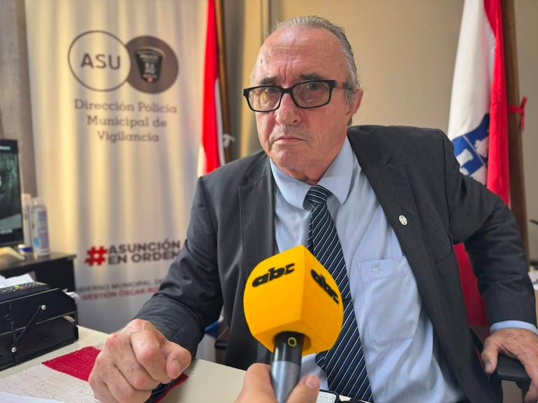 Hombre de mediana edad, con gafas y traje oscuro, sentado en oficina, frente un micrófono con logo de ABC Color.