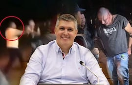 Hombre sonriente con camisa clara en primer plano, un grupo de personas interactuando en un ambiente exterior.