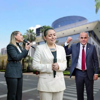 Lizarella Valiente con micrófono en atuendo negro, Andrea Valobra en traje blanco, y Basilio Núñez levantando el puño.