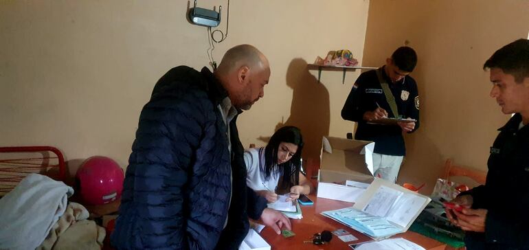 El agente fiscal Víctor Adolfo Santander, labra el acta de intervención junto con su asistente y el personal policial que acompañó los procedimientos en el marco de la investigación del citado caso.