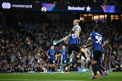 Manchester City's Norwegian striker #09 Erling Haaland (C) has this header saved during the UEFA Champions League, league phase football match between Manchester City and Inter Milan at the Etihad stadium, in Manchester, north-west England, on September 18, 2024 (Photo by Paul ELLIS / AFP)