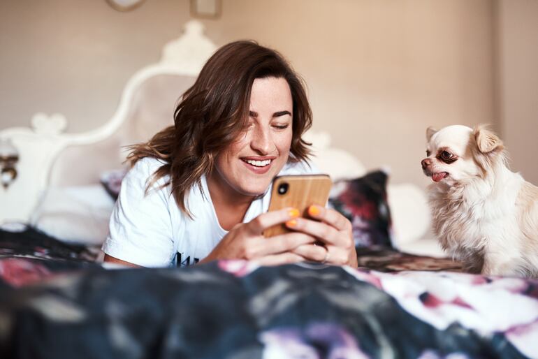 Perro y su humana buscan hoteles dog-friendly en una app.