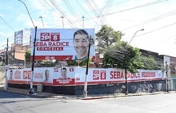 Vallas publicitarias de campaña electoral en Asunción con el rostro sonriente de Seba Radice y colores rojo y blanco.