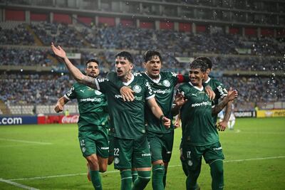 Palmeiras' Uruguayan defender #22 Joaquin Piquerez celebrates with teammates after scoring a penalty during the Copa Libertadores group stage first round football match between Peru's Sporting Cristal and Brazil's Palmeiras at the Nacional stadium in Lima, on April 3, 2025. (Photo by ERNESTO BENAVIDES / AFP)