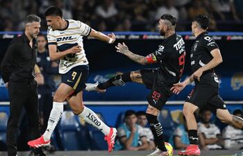 TOPSHOT - Pumas' forward #09 Guillermo Martinez is fouled by Monterrey's Spanish defender #93 Sergio Ramos during the Liga MX Clausura football match between Pumas and Monterrey at the Olimpico Universitario stadium in Mexico City on March 16, 2025. (Photo by Yuri CORTEZ / AFP)