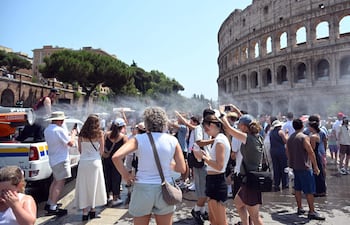 Personal de Protección Civil refresca a turistas con un cañón de agua frente al Coliseo, en Roma, Italia, el 16 de julio de 2026. Ese día, las temperaturas alcanzaron los 36 °C y, debido a la persistente ola de calor, la capital italiana se encontraba bajo alerta roja por altas temperaturas.