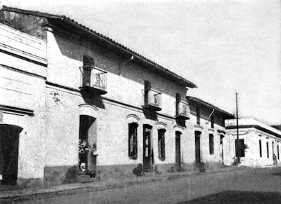 Calle vacía con edificios coloniales, balcones y ventanas en blanco y negro que evocan la historia de Asunción.