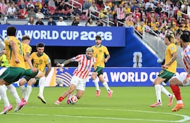 Julio Enciso intenta escapar de varios jugadores australianos que fueron firmes en la marca.